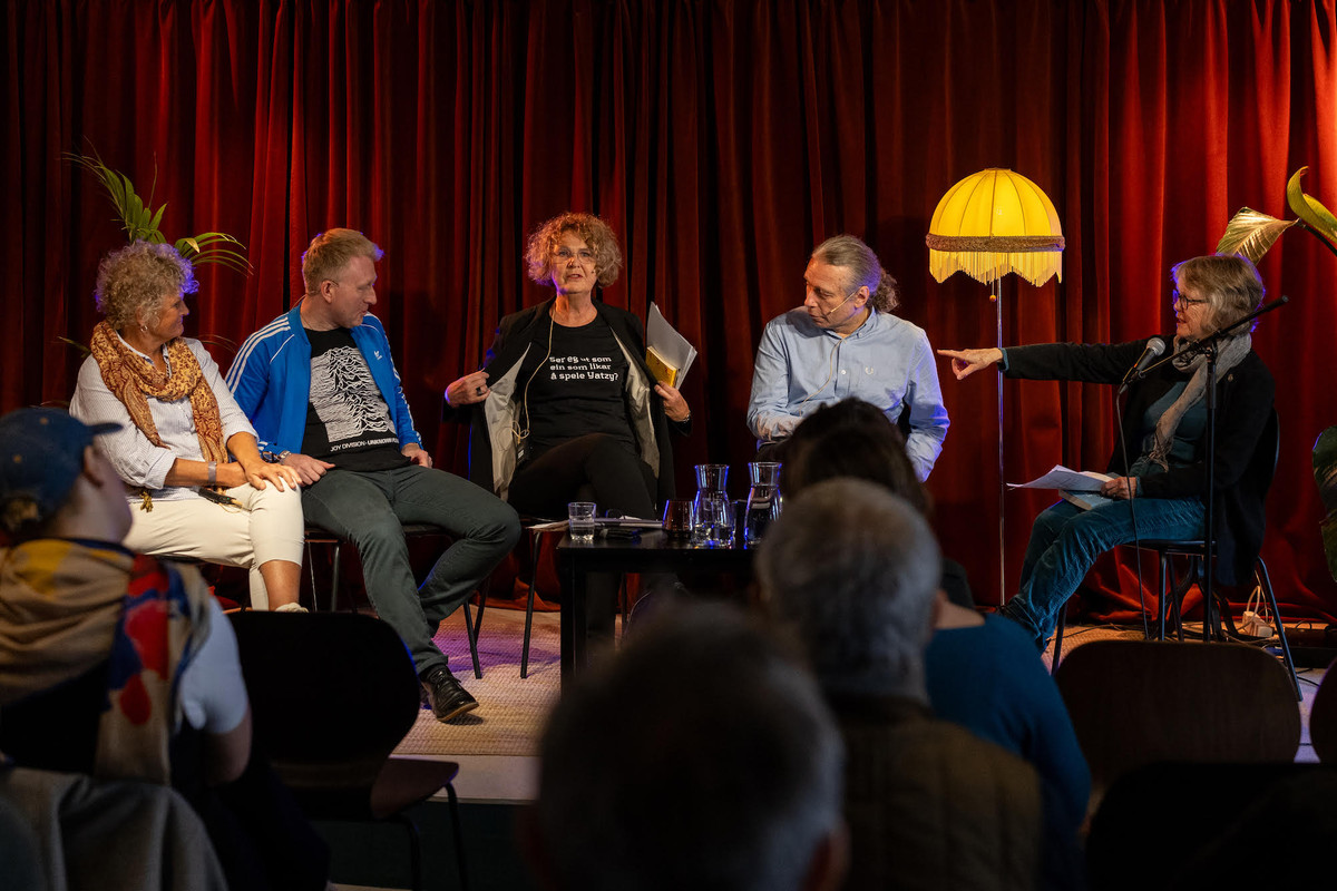 Five people engaging in debate.